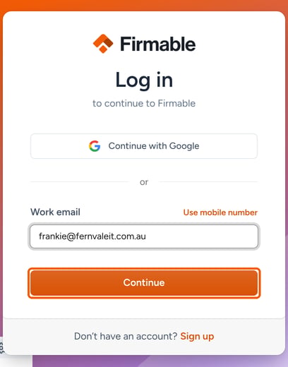 The Firmable Log in page with a work email entered and the Continue button highlighted
